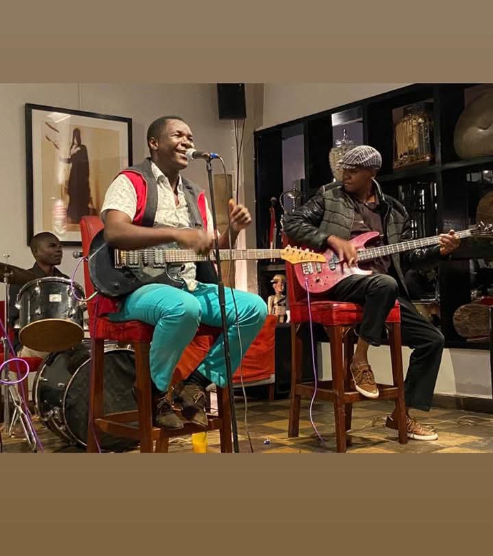 Haston Kombe playing guitar